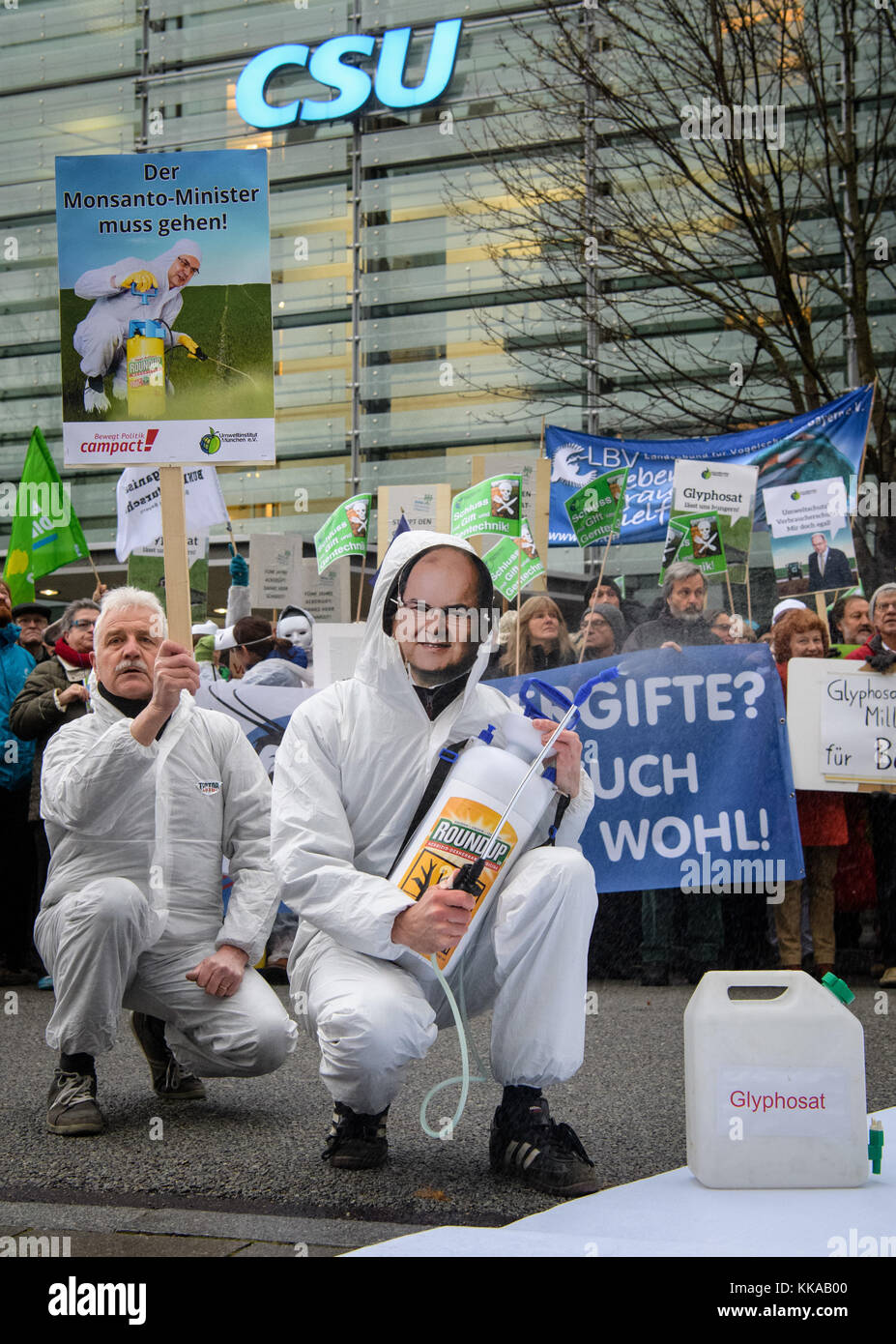 An activist wearing a mask of Minister of Agriculture Schmidt (CSU) sprays with water during a demonstration organised by differend environmental organisations against glyphosat in front of the CSU party headquarters in Munich, Germany, 29 November 2017. The demonstration by Bund Naturschutz in Bayern ('Association Natural Protection in Bavaria'), Compact and the Environmental Institute Munich with the motto 'Glyphosat-Skandal muss Konsequenzen haben' (lit. 'Glyphosat-Scandal must have consequences') aims at the vote by Minister of Agriculture Schmidt (CSU) on the readmission of Glyphosat. Pho Stock Photo