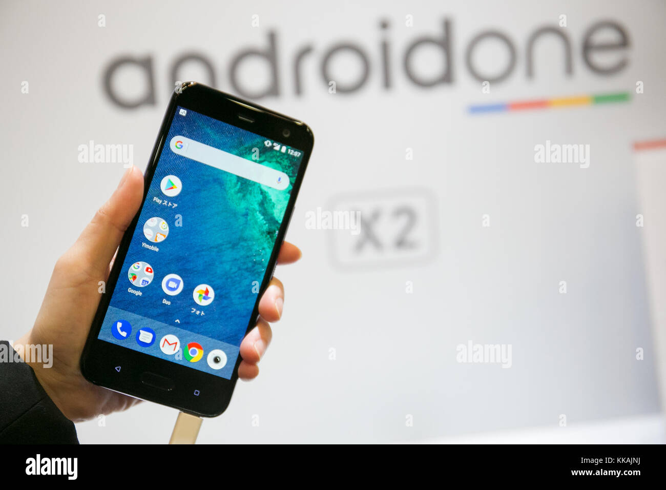 An exhibitor shows a smartphone Android One X2 during a launch event ...