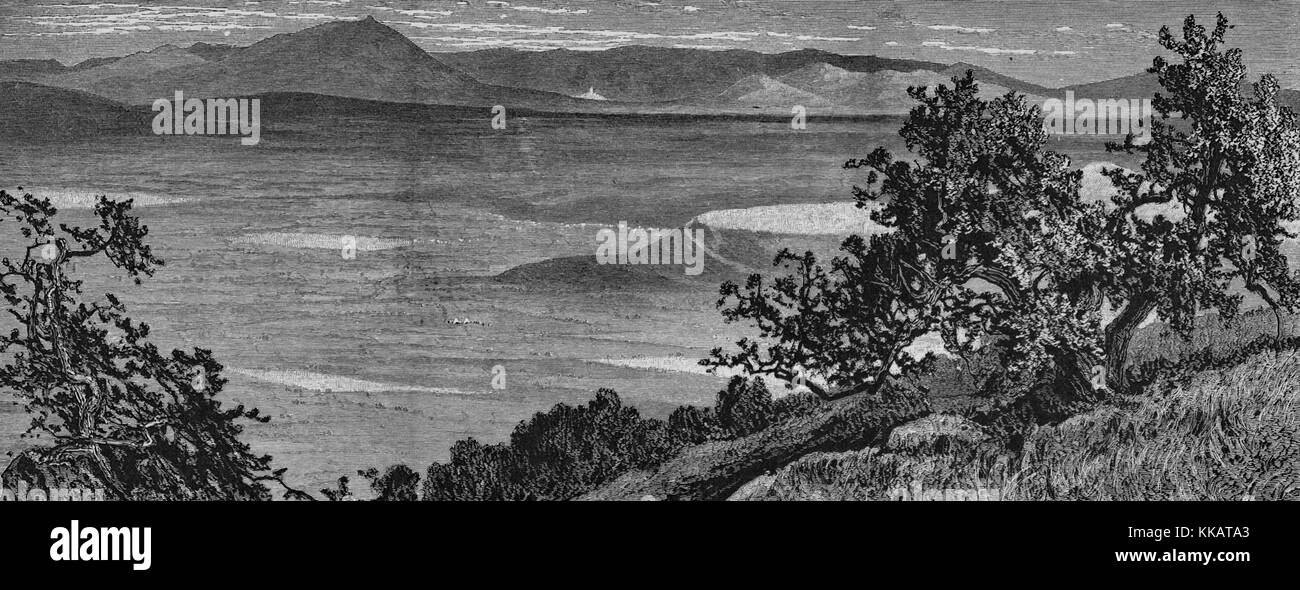 An etching depicting the landscape of the plains of Esdraelon as seen from the heights above El Mahrakah, the village of Jezreel and its white castle can be seen in the center distance, Israel, 1882. From the New York Public Library. Stock Photo