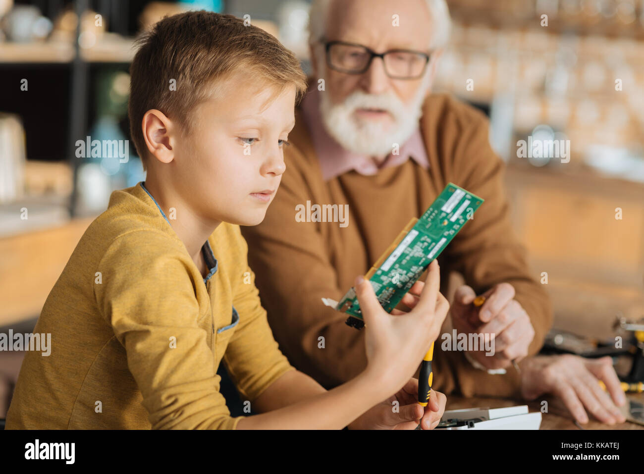 Serious smart boy learning to fix things Stock Photo Alamy