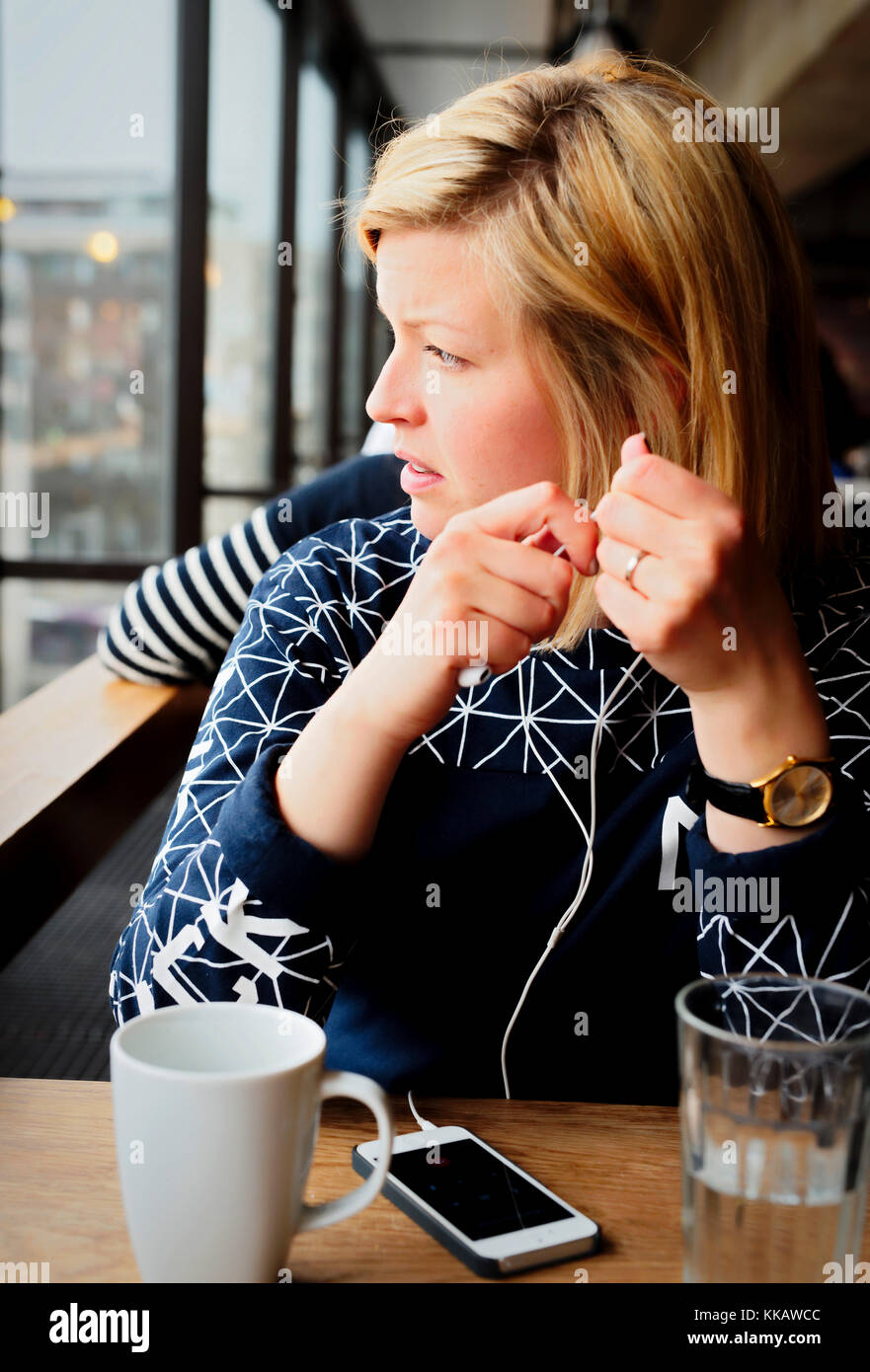 Girl with cellphone in a cafe Stock Photo