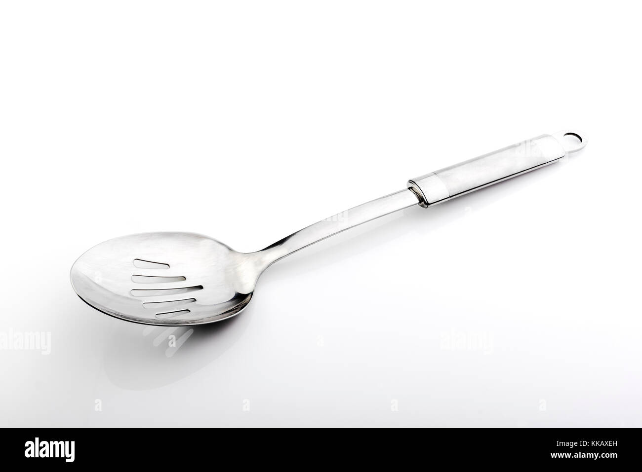 Slotted drainer spoon, stainless steel kitchenware. Stock Photo