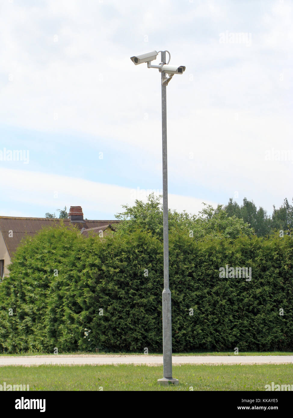 Two security monitoring, video cameras on high metal pole outdoor Stock Photo