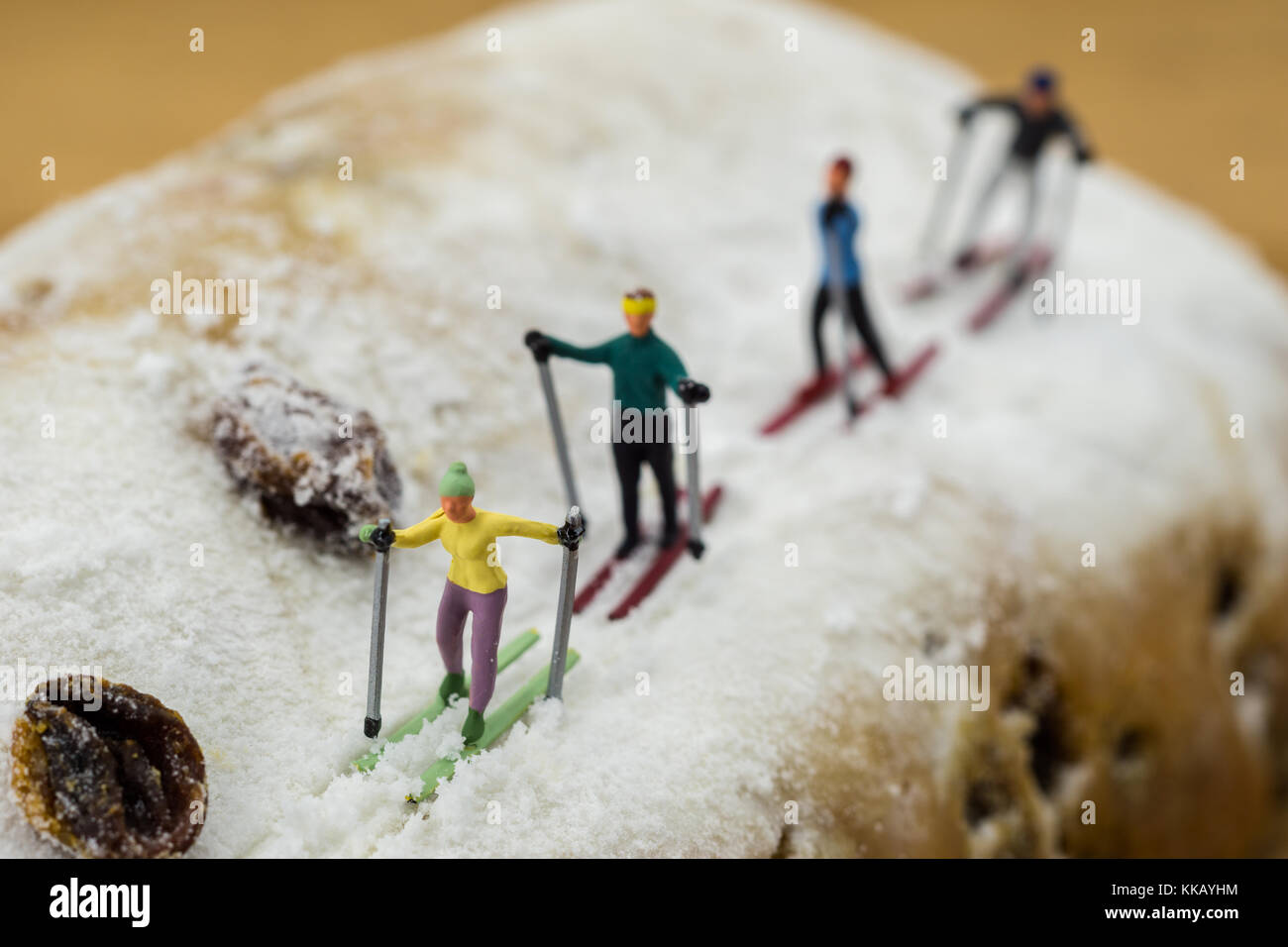 concept Miniature skier skiing on a white cake Stock Photo - Alamy