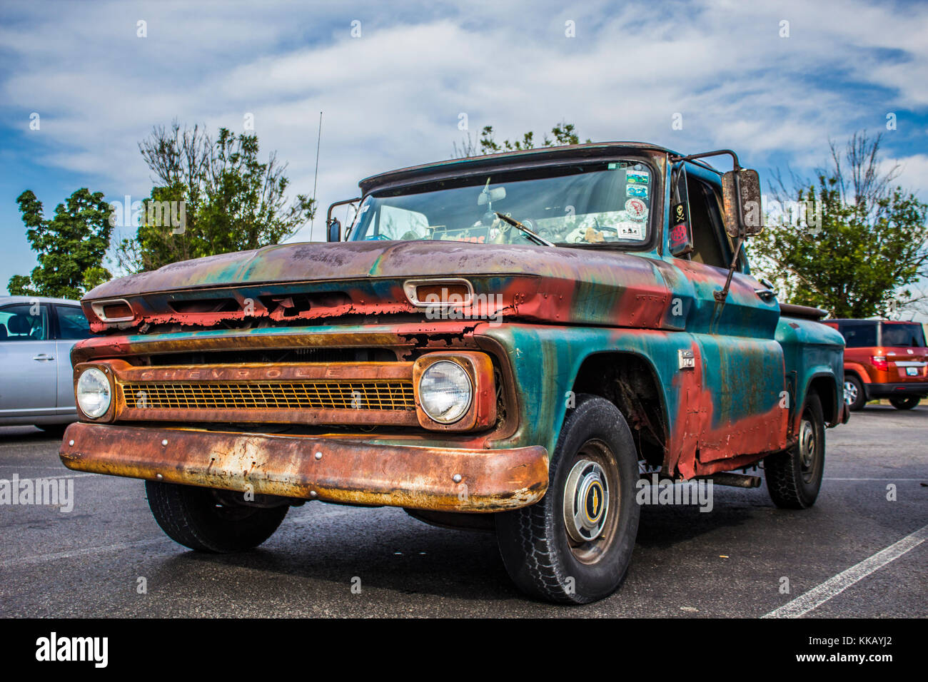 Old truck in a parking lot on a cloudy day. Stock Photo