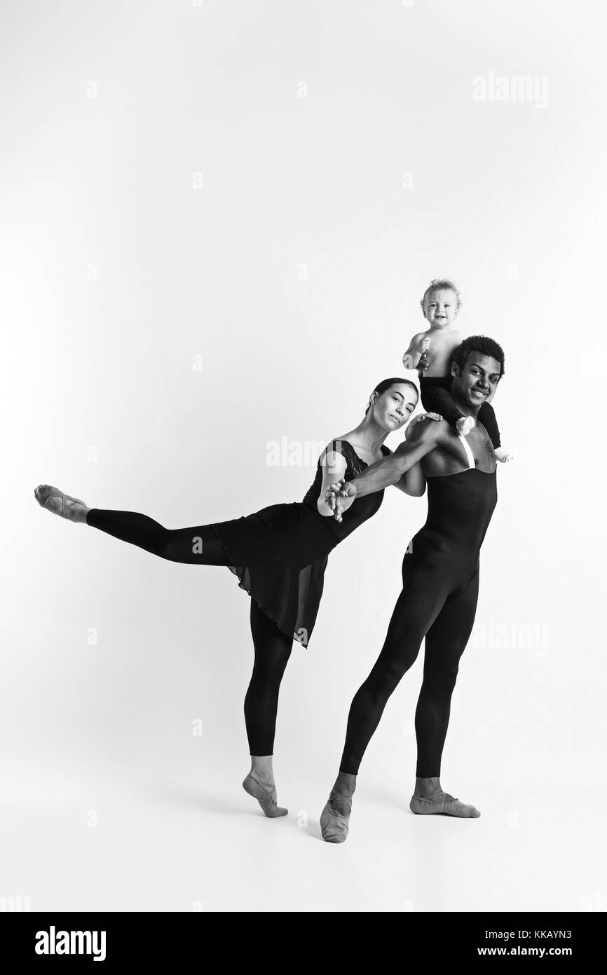 A happy family of ballet dancers on white studio background Stock Photo