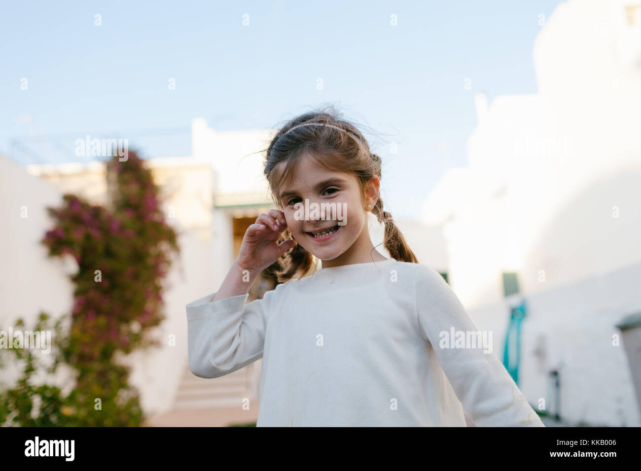 Little smiling girl looking at camera Stock Photo - Alamy