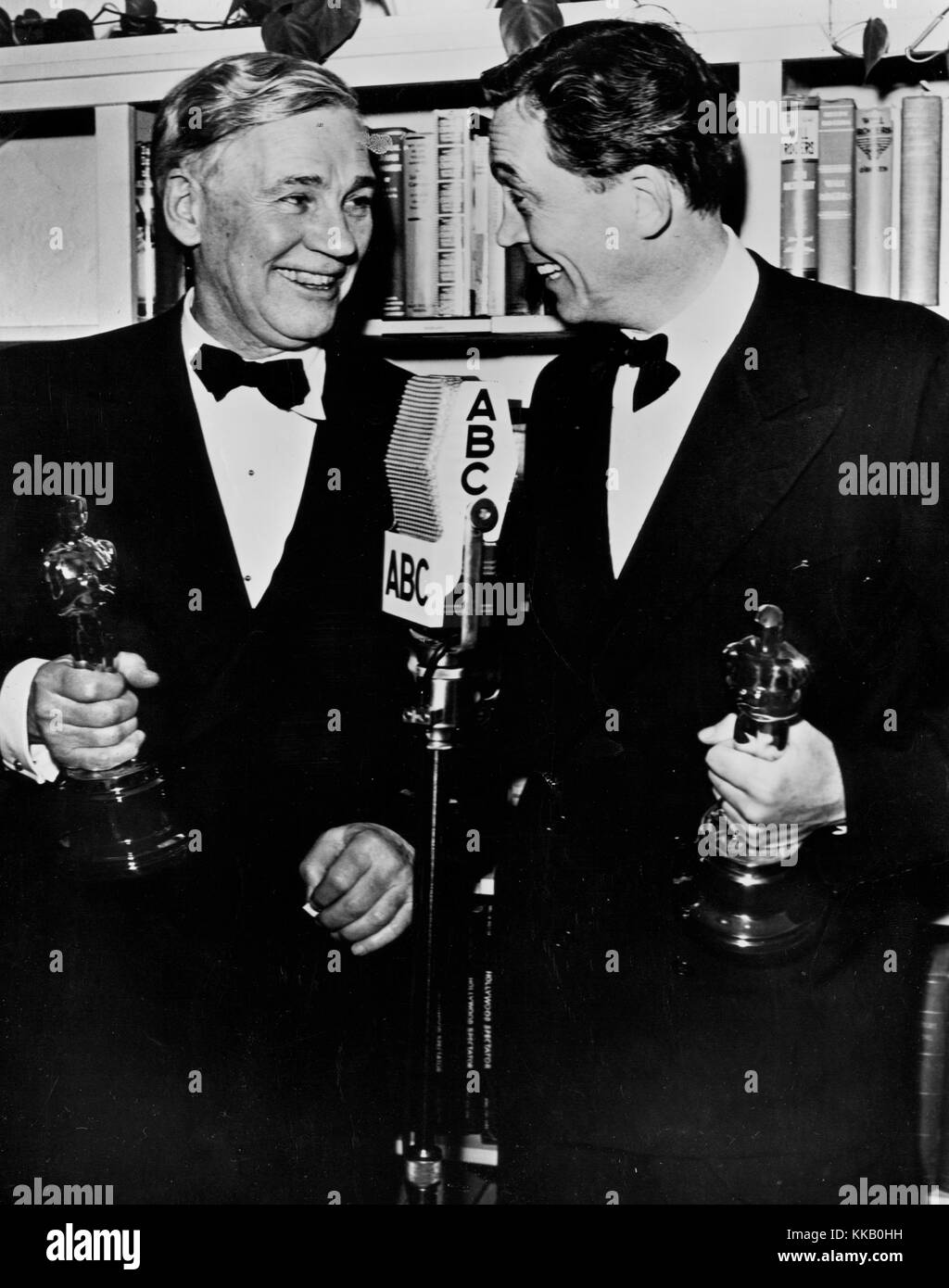 Walter Huston (left) and his son, John Huston, exchange congratulations after they won academy awards for their work in 'Treasure of the Sierra Madre', Walter as best supporting actor and John as director, 1948. Stock Photo