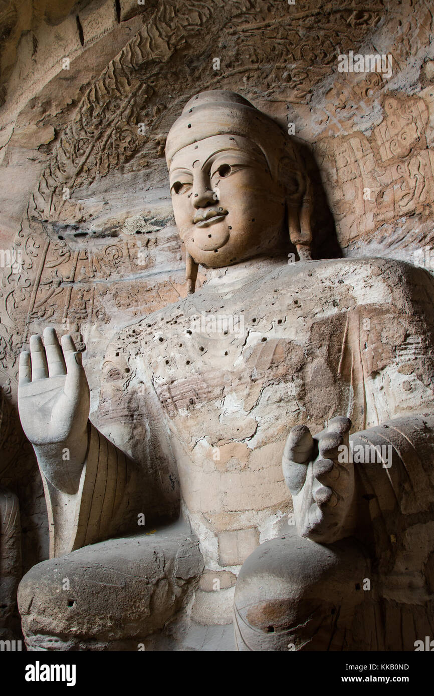 Giant stone Buddha scultpure in one of the main caves at the Yungang Grottos. Stock Photo