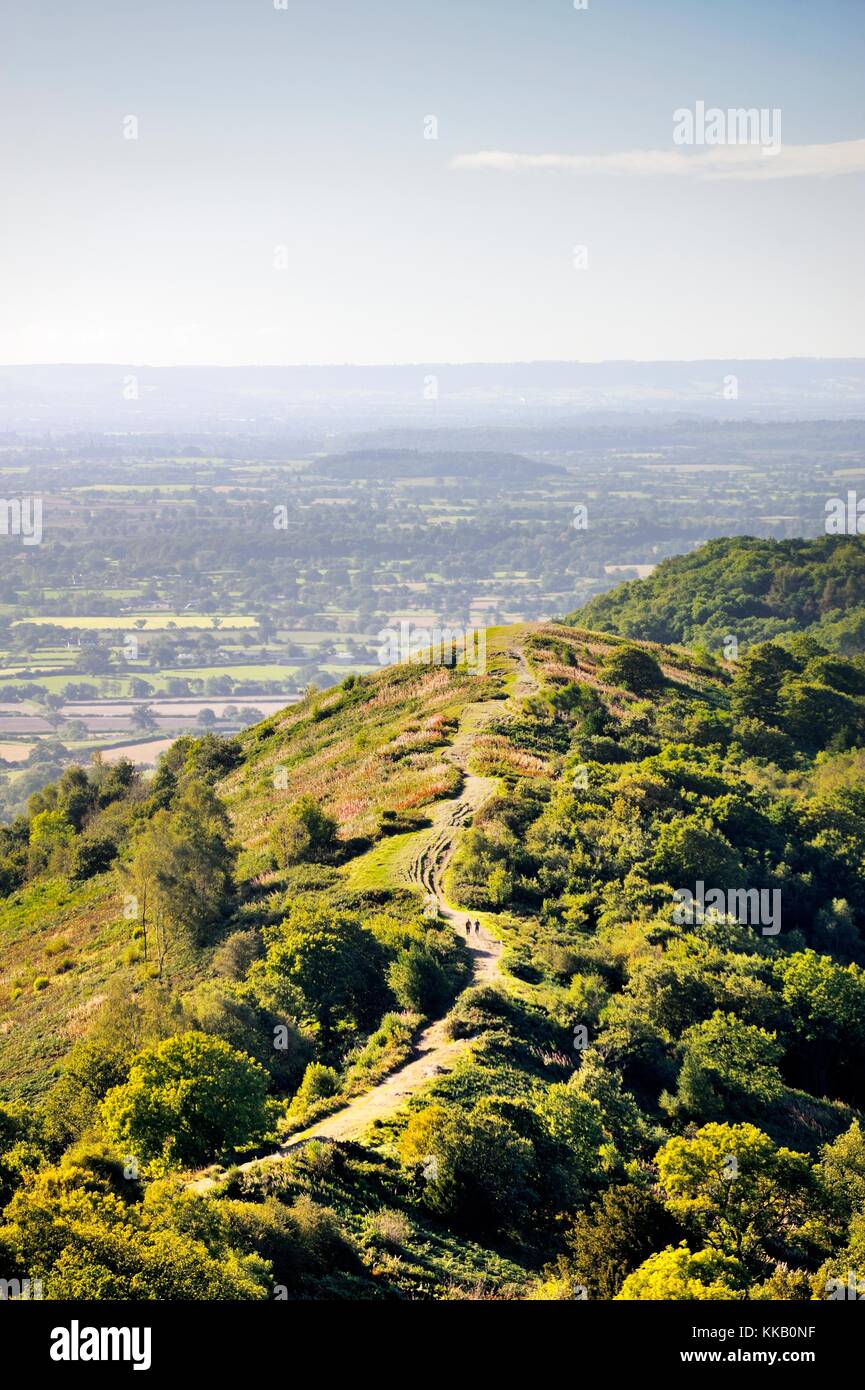 Malvern Hills, England. South from Herefordshire Beacon. Walkers on footpath with the Severn Valley in distance Stock Photo