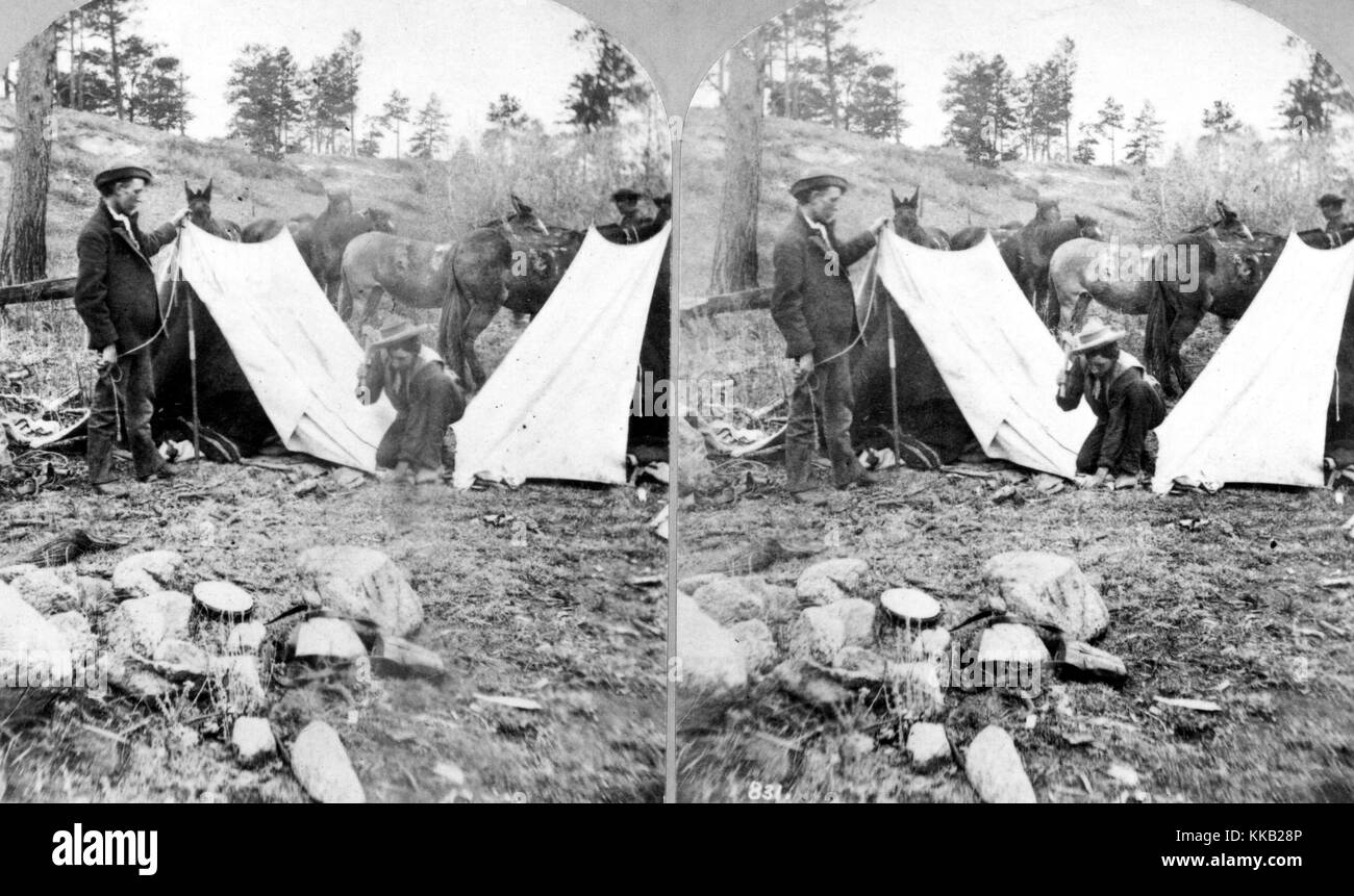 Stereograph of two USGS employees putting up tents in their field camp in the Rocky Mountains, Colorado. Image courtesy USGS. 1874. Stock Photo
