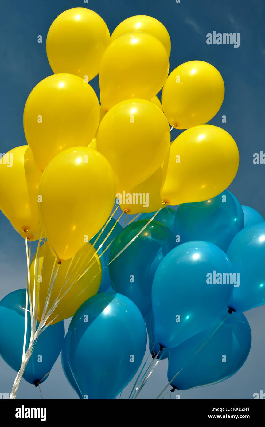 blue and yellow  balloons in the city festival on blue sky background,vertical composition Stock Photo