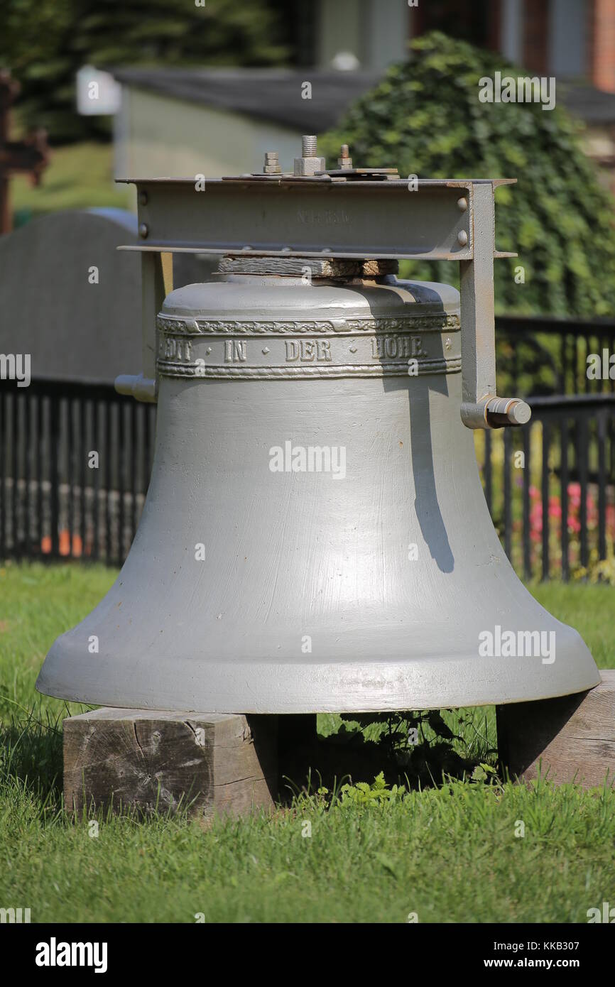 Historic church bell from 1924 on the cemetery of Kroeslin, Germany. Stock Photo