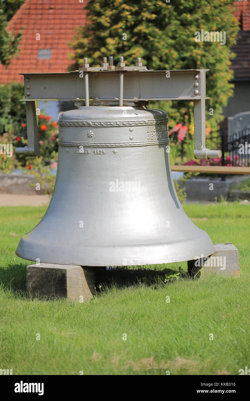 Historic church bell from 1924 on the cemetery of Kroeslin, Germany. Stock Photo