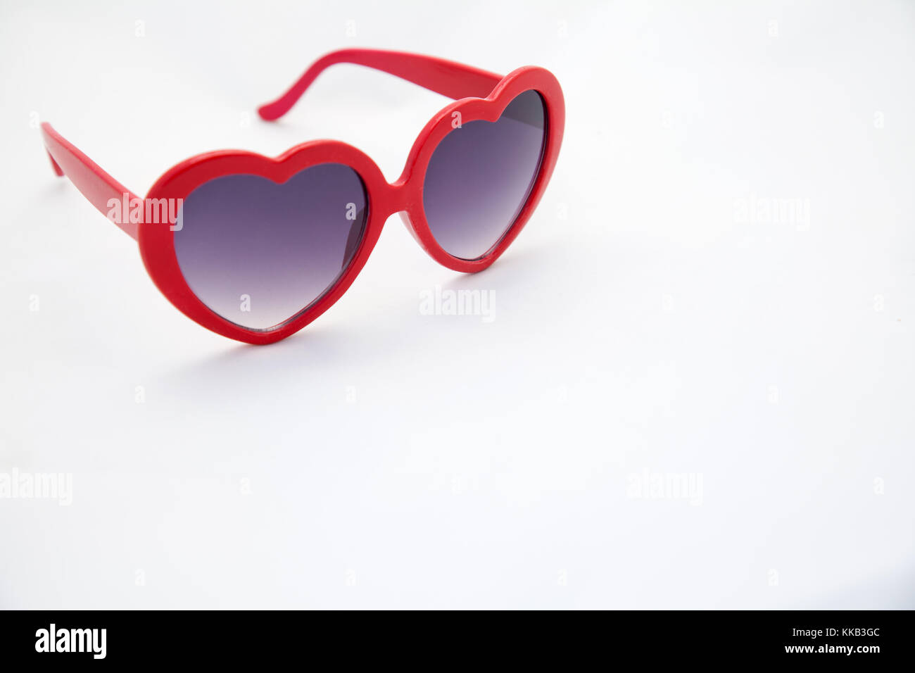 Heart shaped sunglasses on white background with copy space Stock Photo