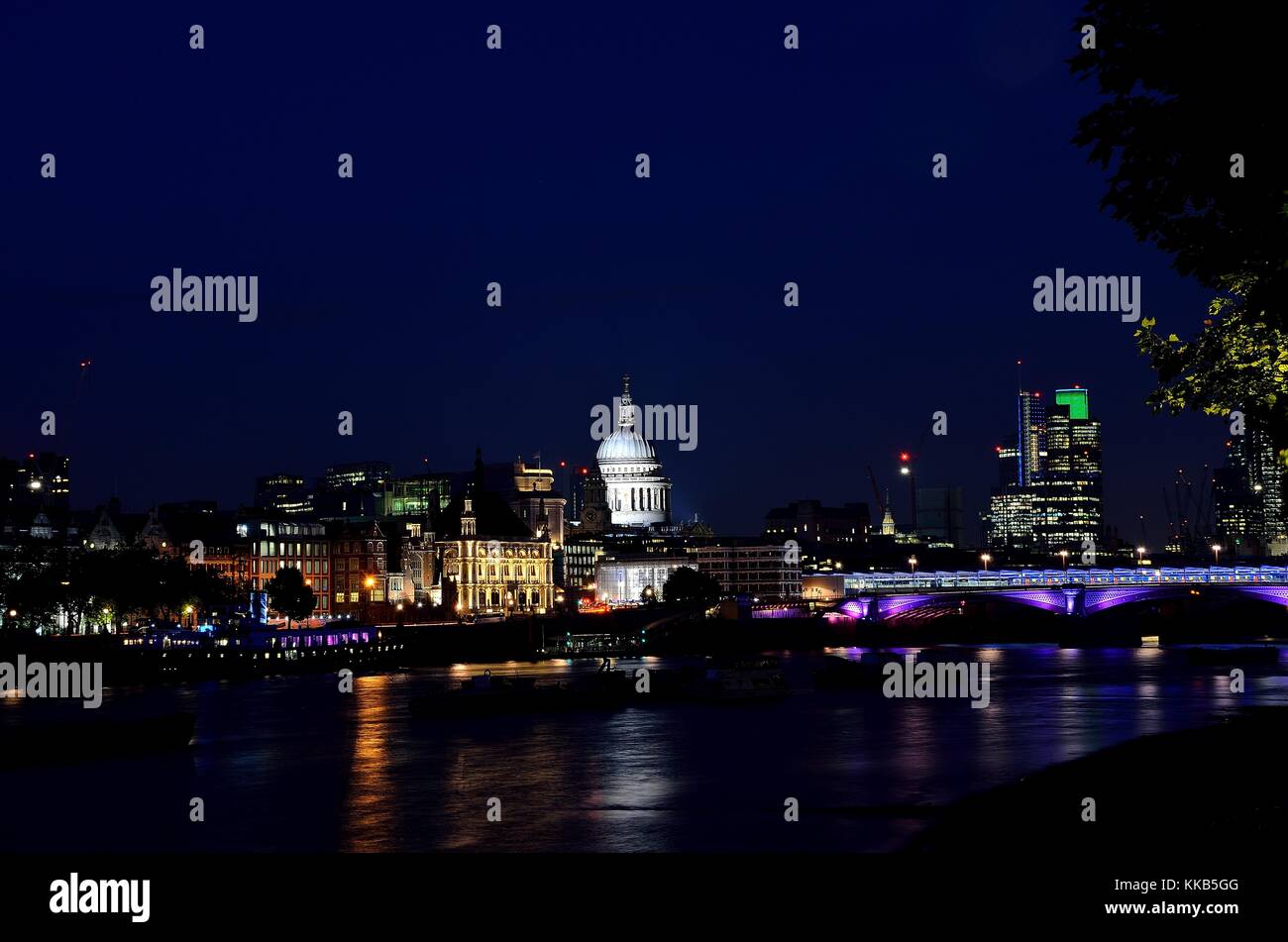 St Pauls Cathedral taken at night photographed from across the Millennium Bridge over the River Thames, giving of some nice reflections. Stock Photo