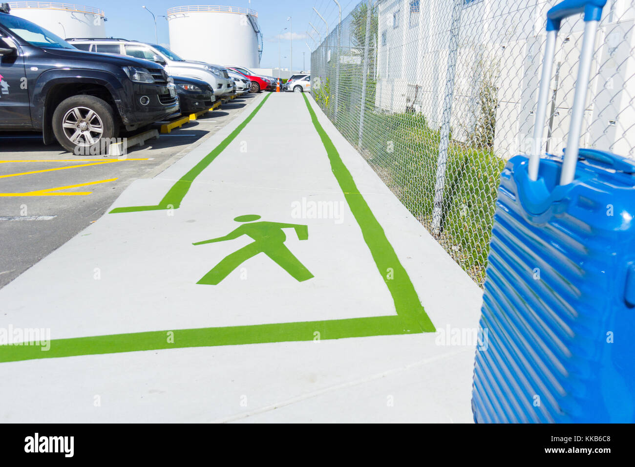 AUCKLAND, NEW ZEALAND - NOVEMBER 27, 2017; Green lines and green walking man sign on footpath showing way between international and domestic terminals Stock Photo