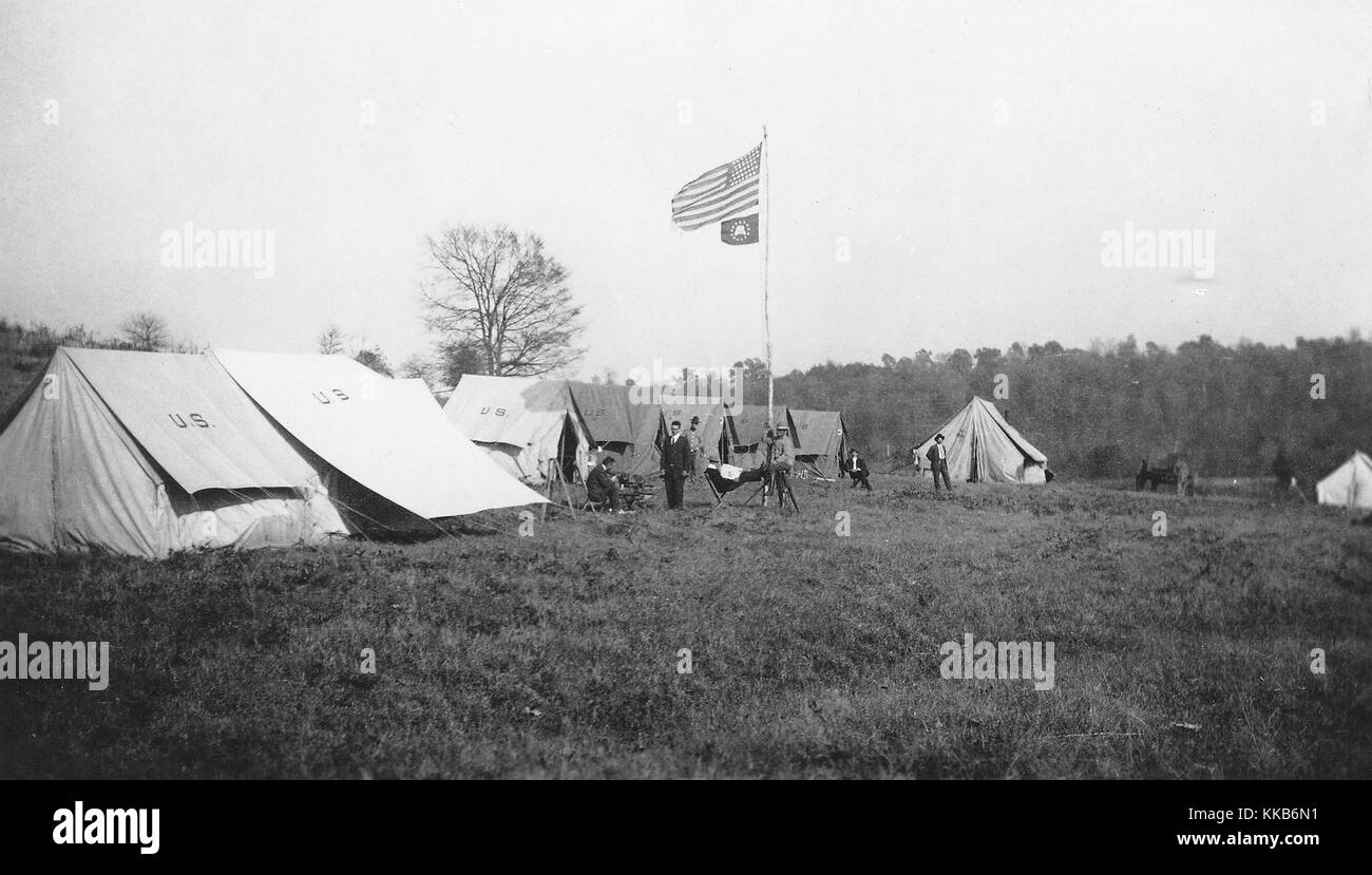 Members of a USGS topographic mapping crew can be seen standing outside of their field camp tents. Image courtesy USGS. 1900. Stock Photo