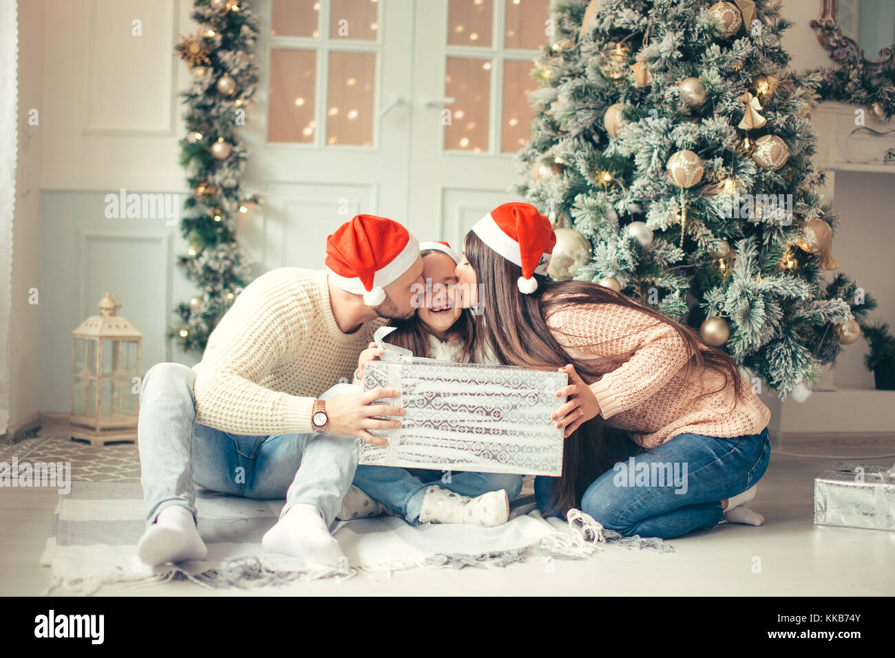 Surprised Little Girl With Christmas Gifts Near A Christmas Tree At Stock Photo Alamy