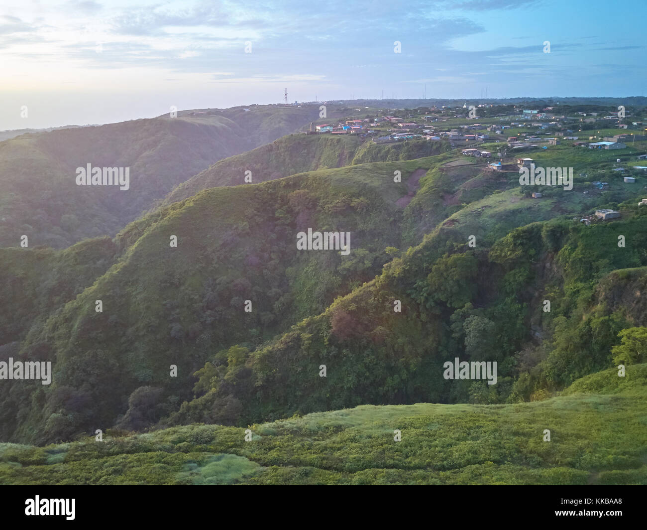 Panorama of houses on green hills in dusk time. Poor people homes in third country Stock Photo