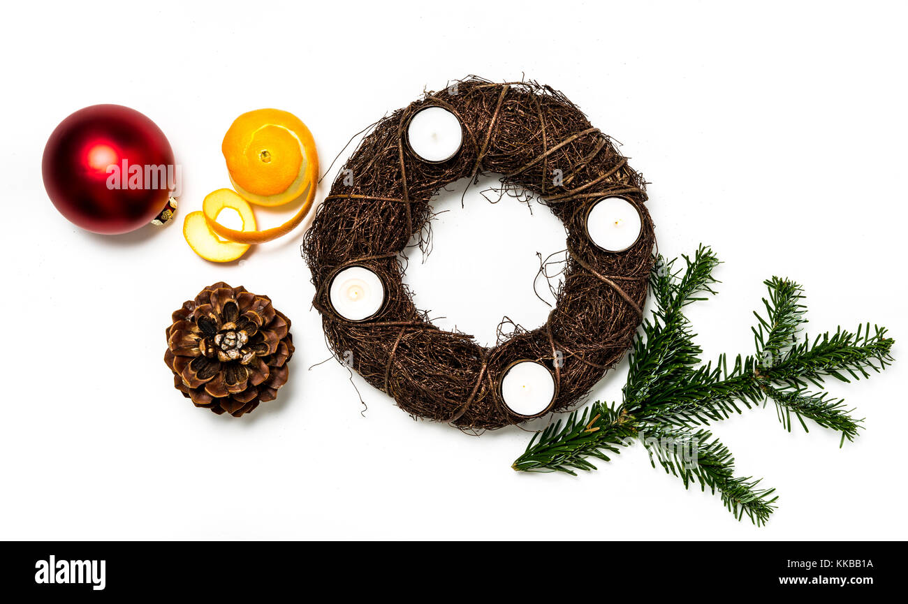 Top view of an advent wreath Happy X-Mas Time. Christmas composition. Christmas decoration, pine cone, branches, a peeled orange. White background. Fl Stock Photo