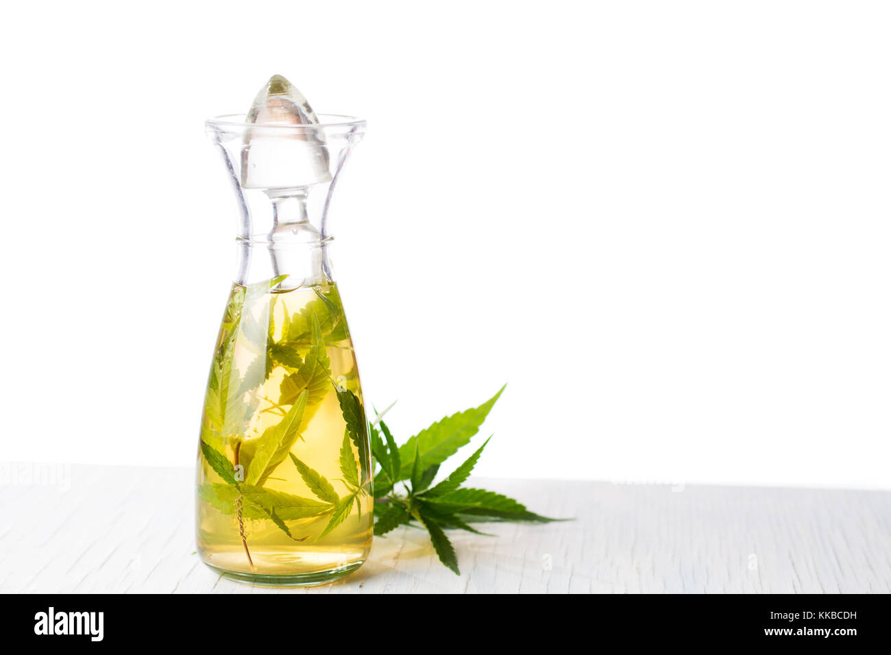 Marijuana alcohol drink in a bottle with leaves Stock Photo