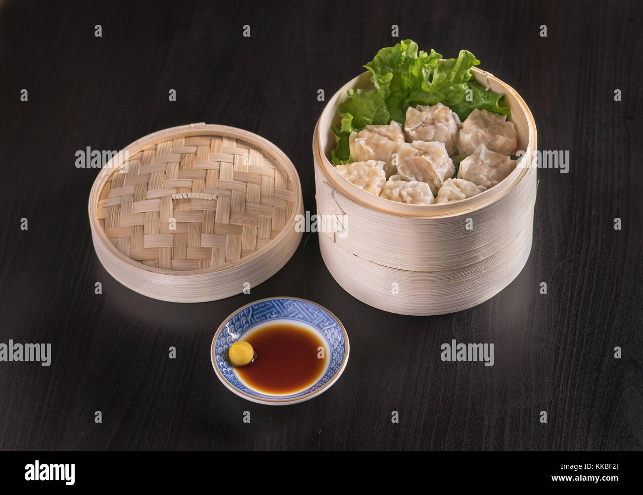 Freshly steamed dumplings in a traditional Chinese bamboo bowl Stock