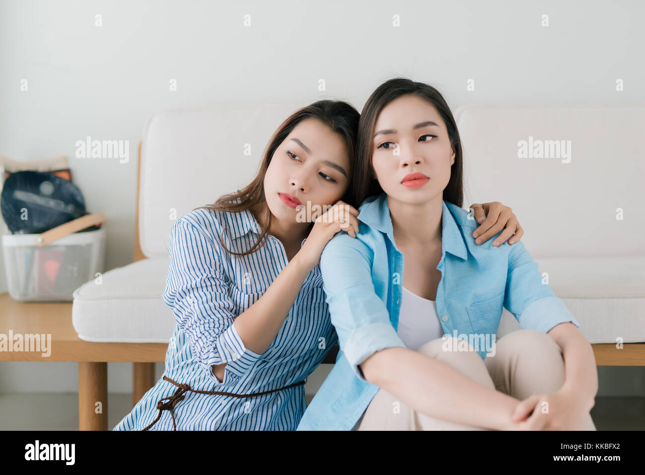 Portrait of young sad girl and friend supporting her Stock Photo - Alamy