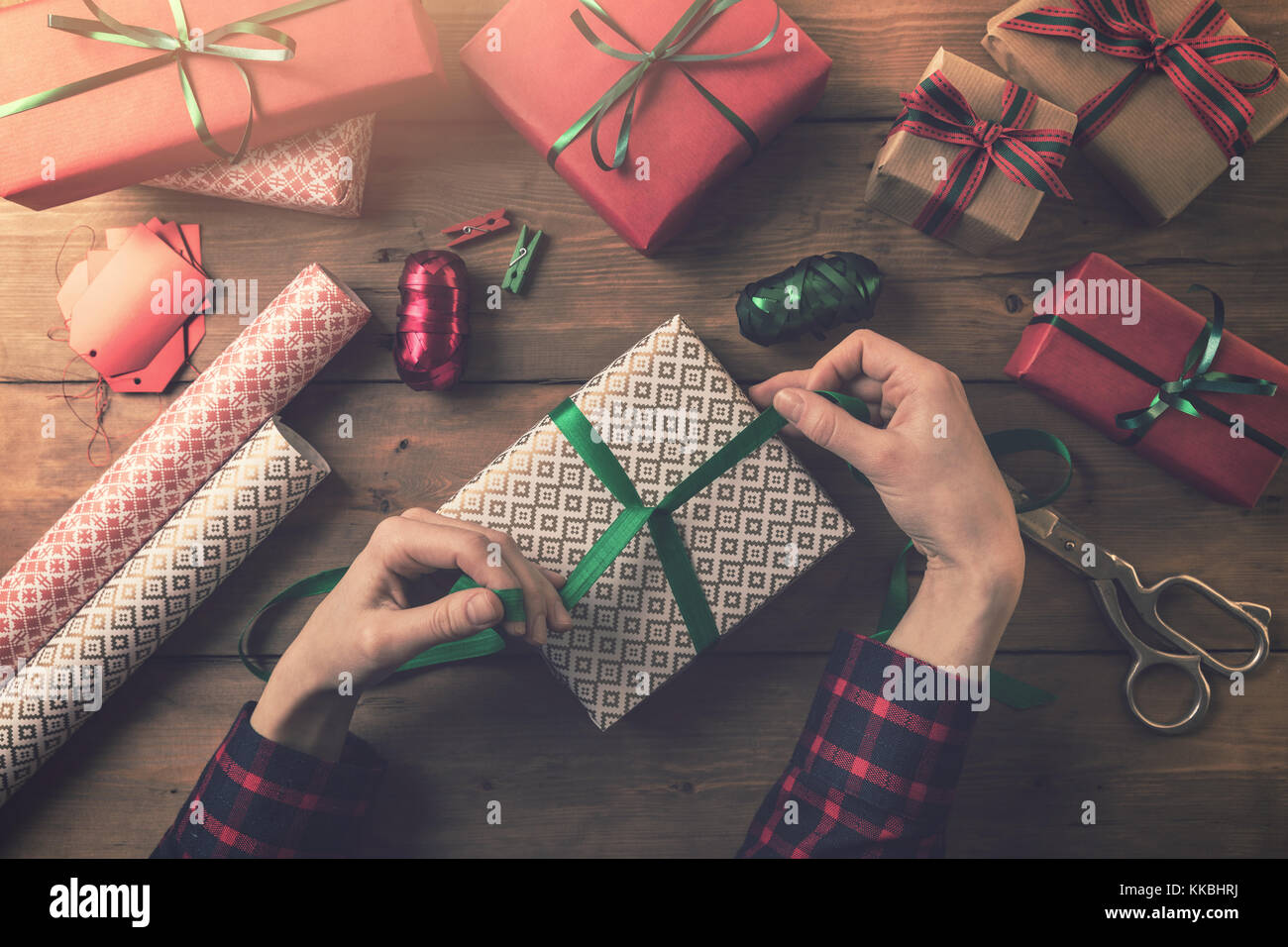 gift wrapping. woman tie a ribbon bow Stock Photo