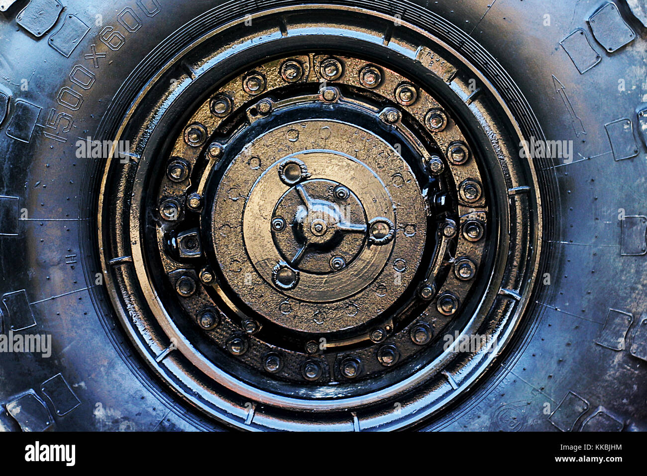 Close up of military vehicle wheel. Large off road tire abstract background. Stock Photo