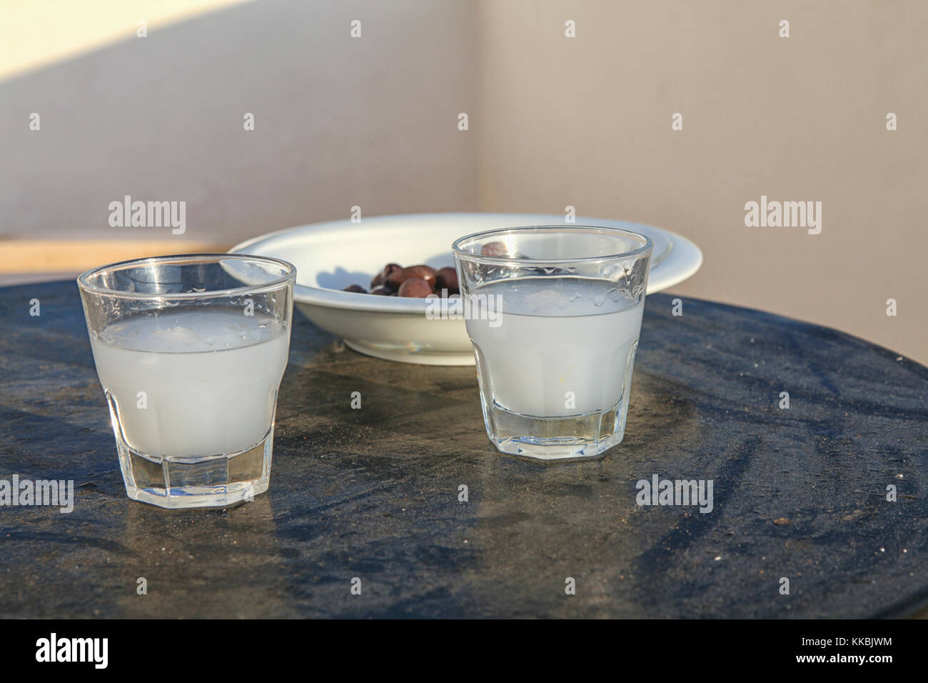 Ouzo in glasses and olives Stock Photo
