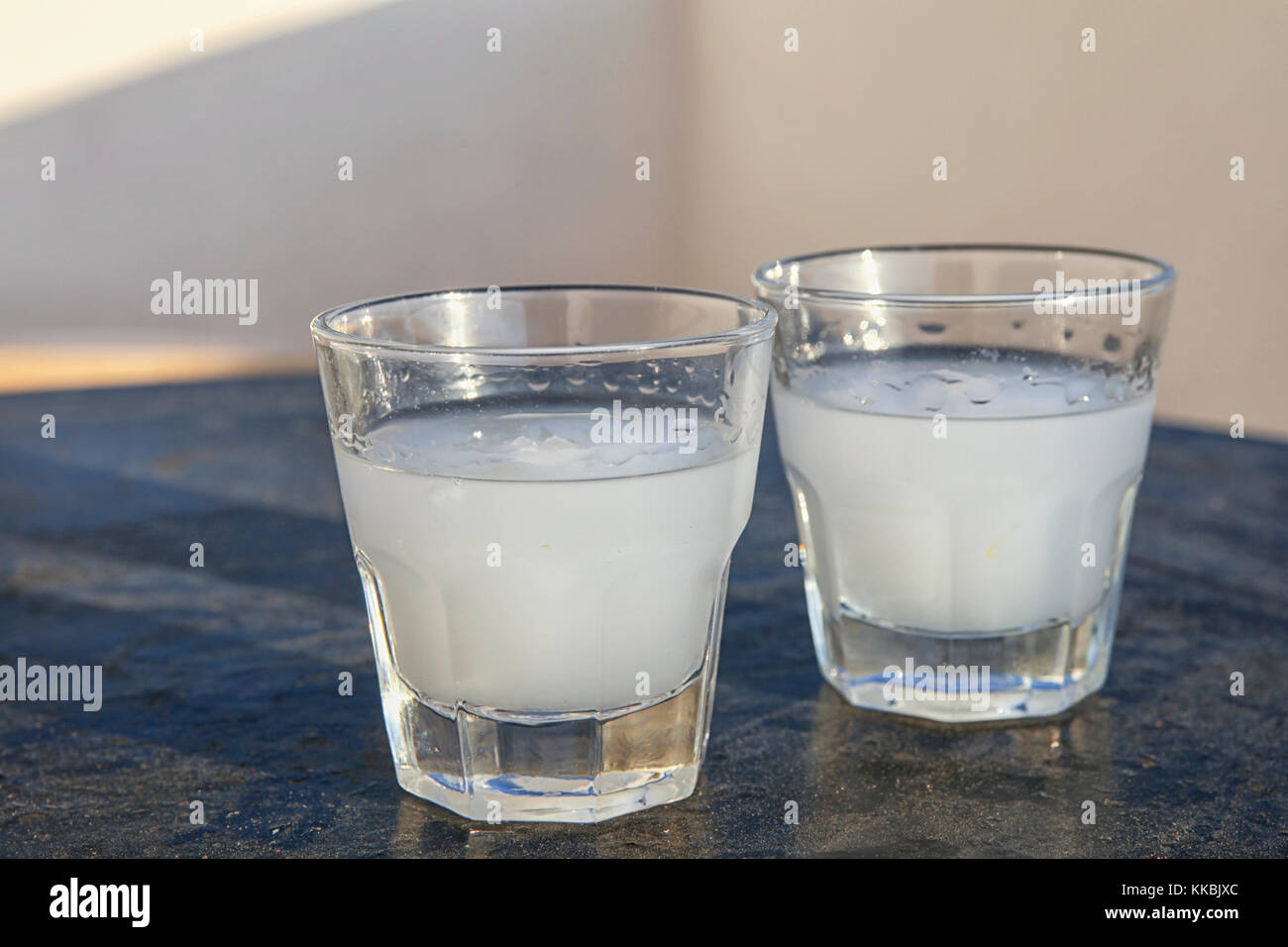 Two glasses of ouzo on a greek cafe table Stock Photo