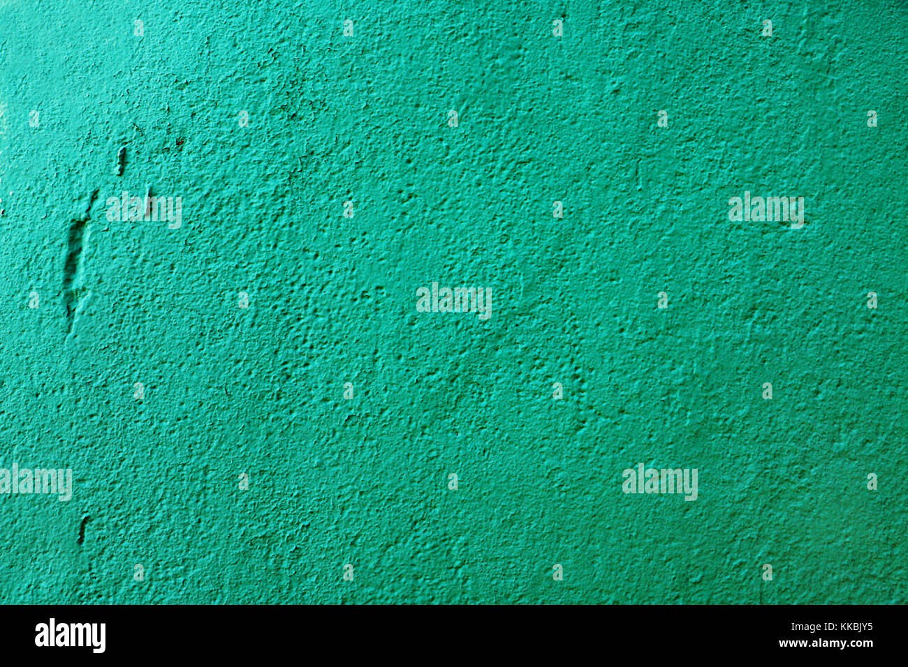 Concrete vintage wall background, old grunge wall painted with green dye. Cement wall texture. Stock Photo