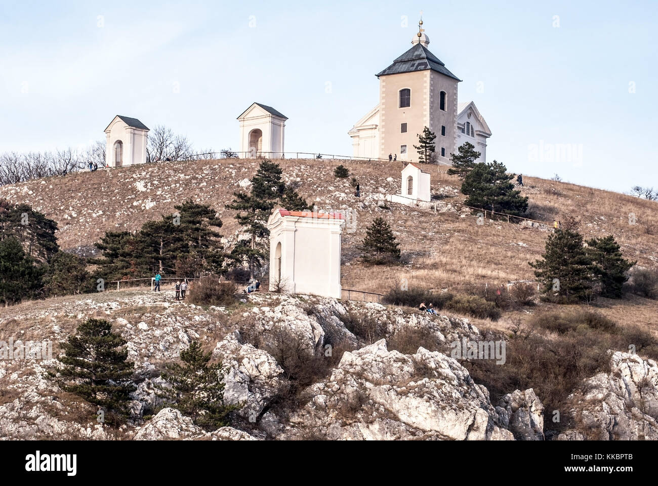 Svaty kopecek hill above Mikulov city in Czech republic with church, chapel, limestone rocks, grass and clear sky during springtime Stock Photo