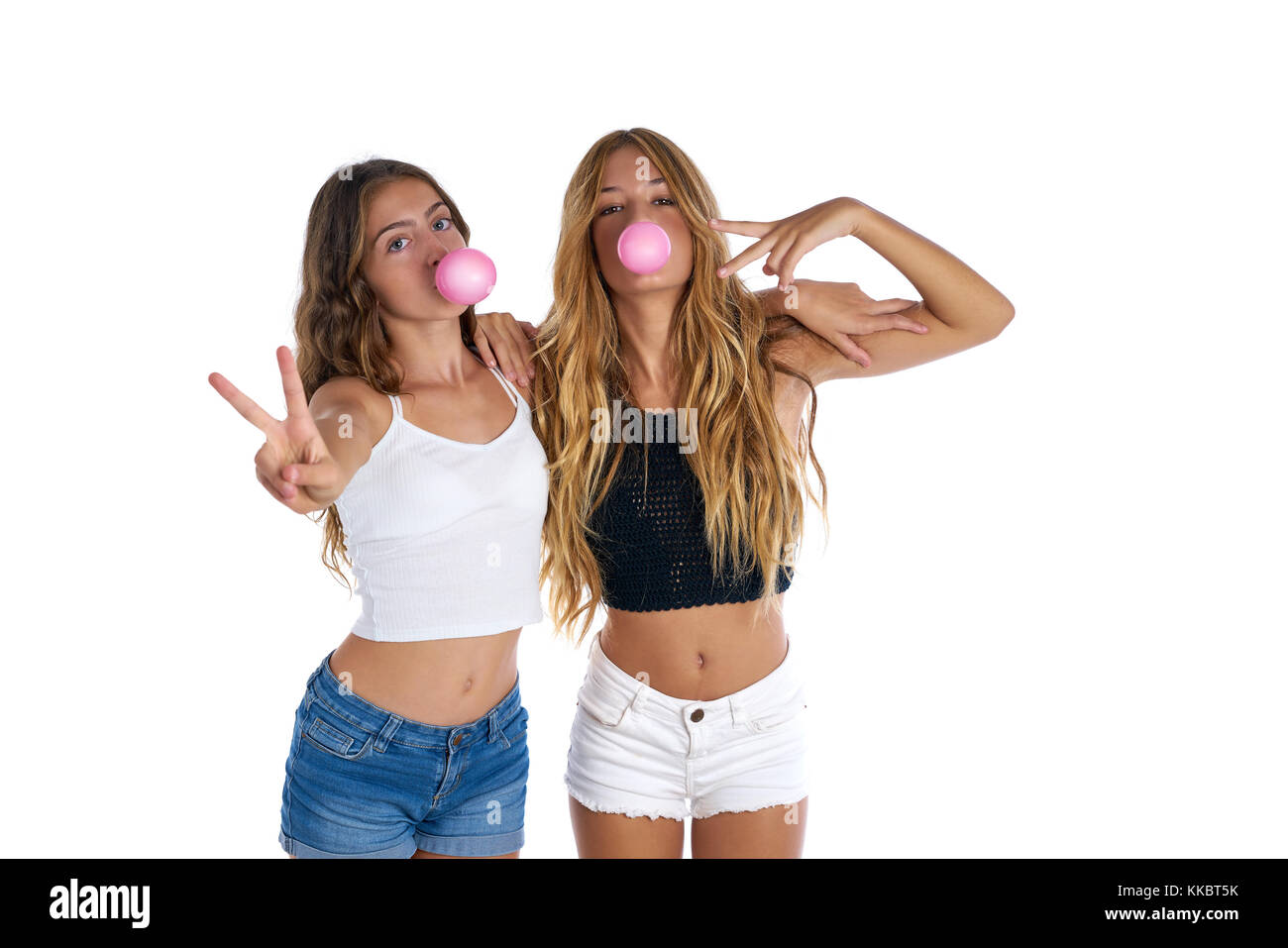 Best friends teen girls with bubble gum on white background Stock Photo