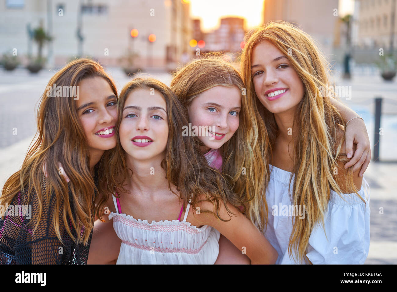 Best friends teen girls at sunset in the city group Stock Photo