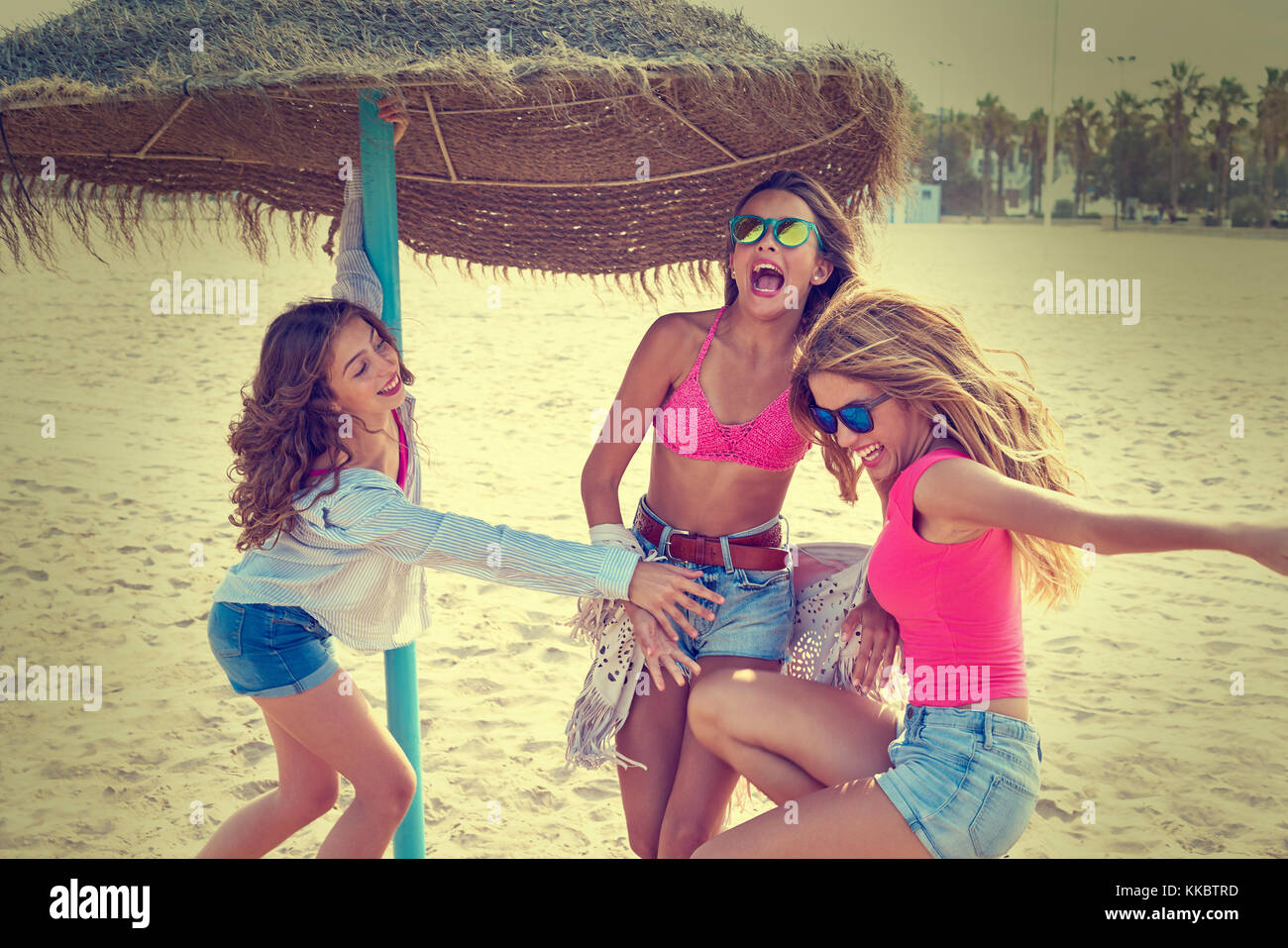 Teen Best Friends Girls Under Thatch Umbrella Having Fun On A Beach   Teen Best Friends Girls Under Thatch Umbrella Having Fun On A Beach KKBTRD 