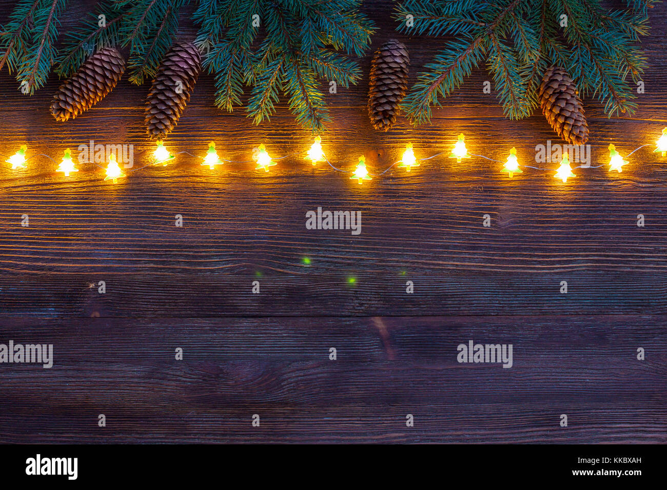 Christmas sparkling Garland with branches of fir tree and cones on the ...
