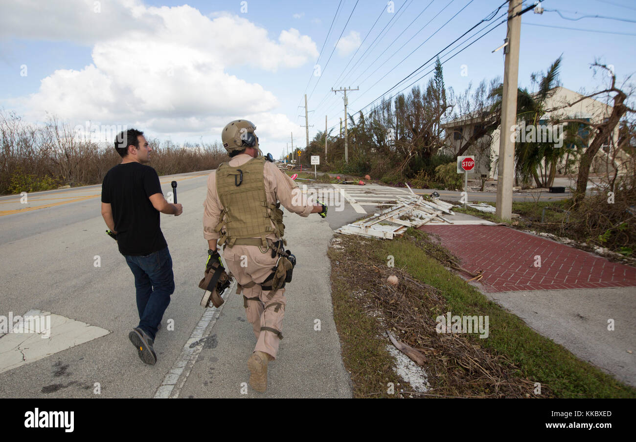 Weather Channel reporter Mickey Hohol (left) surveys the damage in the aftermath of Hurricane Irma September 12, 2017 in Cudjoe Key, Florida.  (photo by Glenn Fawcett via Planetpix) Stock Photo