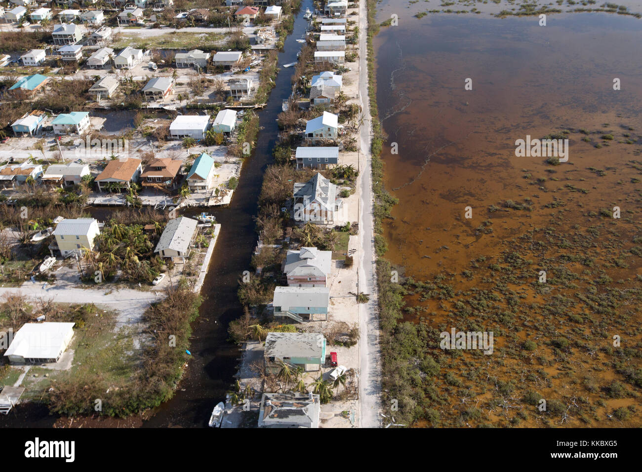 Aerial view of damaged homes, murky water, and flooded streets in the aftermath of Hurricane Irma September 12, 2017 in Homestead, Florida.  (photo by Glenn Fawcett via Planetpix) Stock Photo