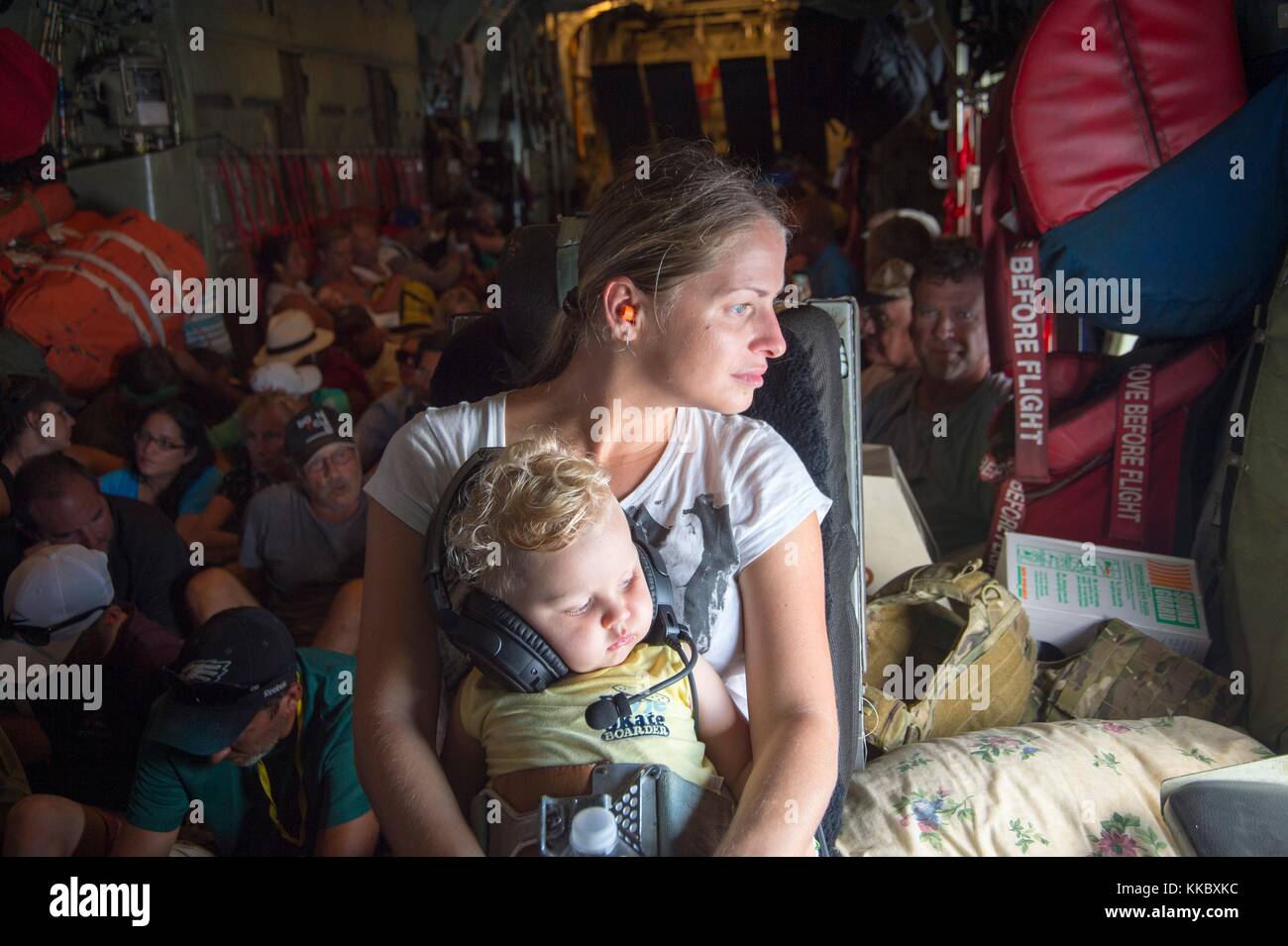 U.S. Air National Guard soldiers evacuate St. Maarten residents on an HC-130 King aircraft during relief efforts in the aftermath of Hurricane Irma September 10, 2017 in San Juan, Puerto Rico.  (photo by Erin Mill via Planetpix) Stock Photo