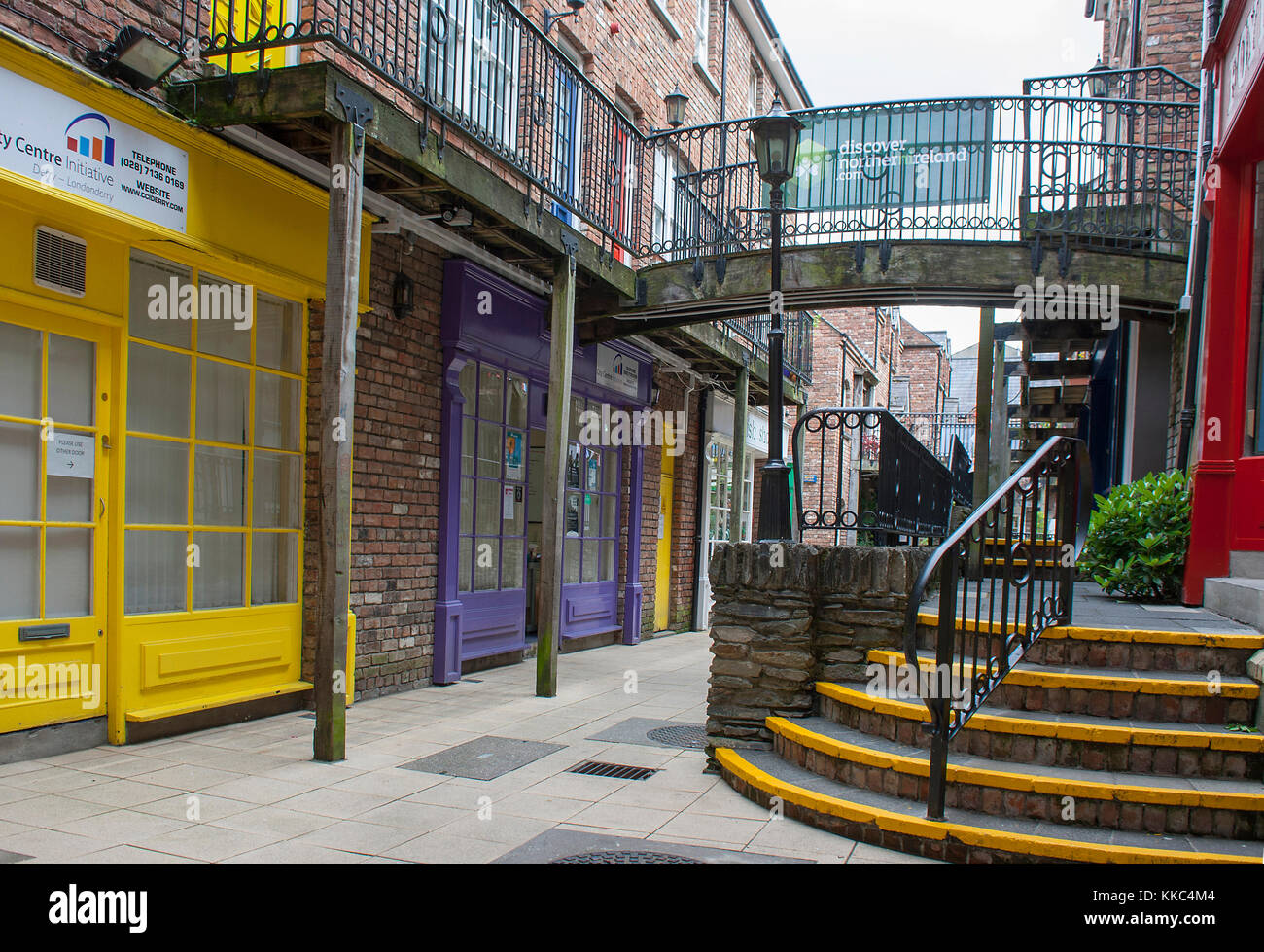 A footpath with handrail leading to shops in the craft village inside the walls of the maiden city of Londonderry in Northern Ireland that has a histo Stock Photo