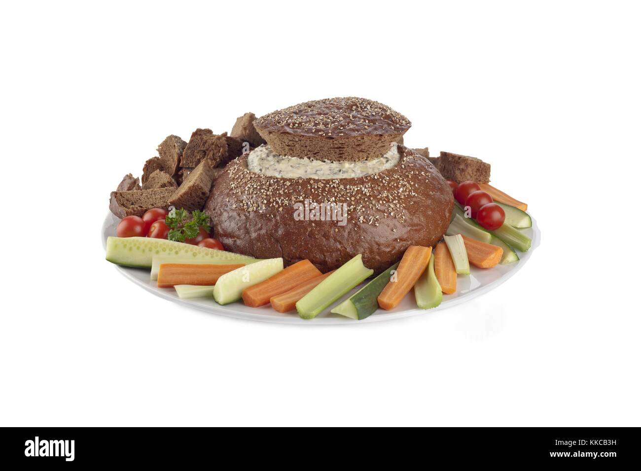 pumpernickel bread filled by spinach dip with vegetables slices Stock