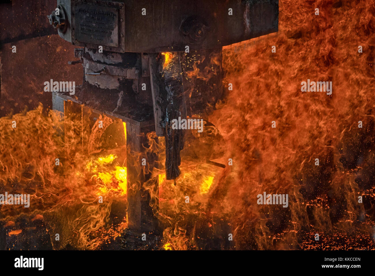 An close view of an industrial furnace being emptied with fire and flames predominant Stock Photo