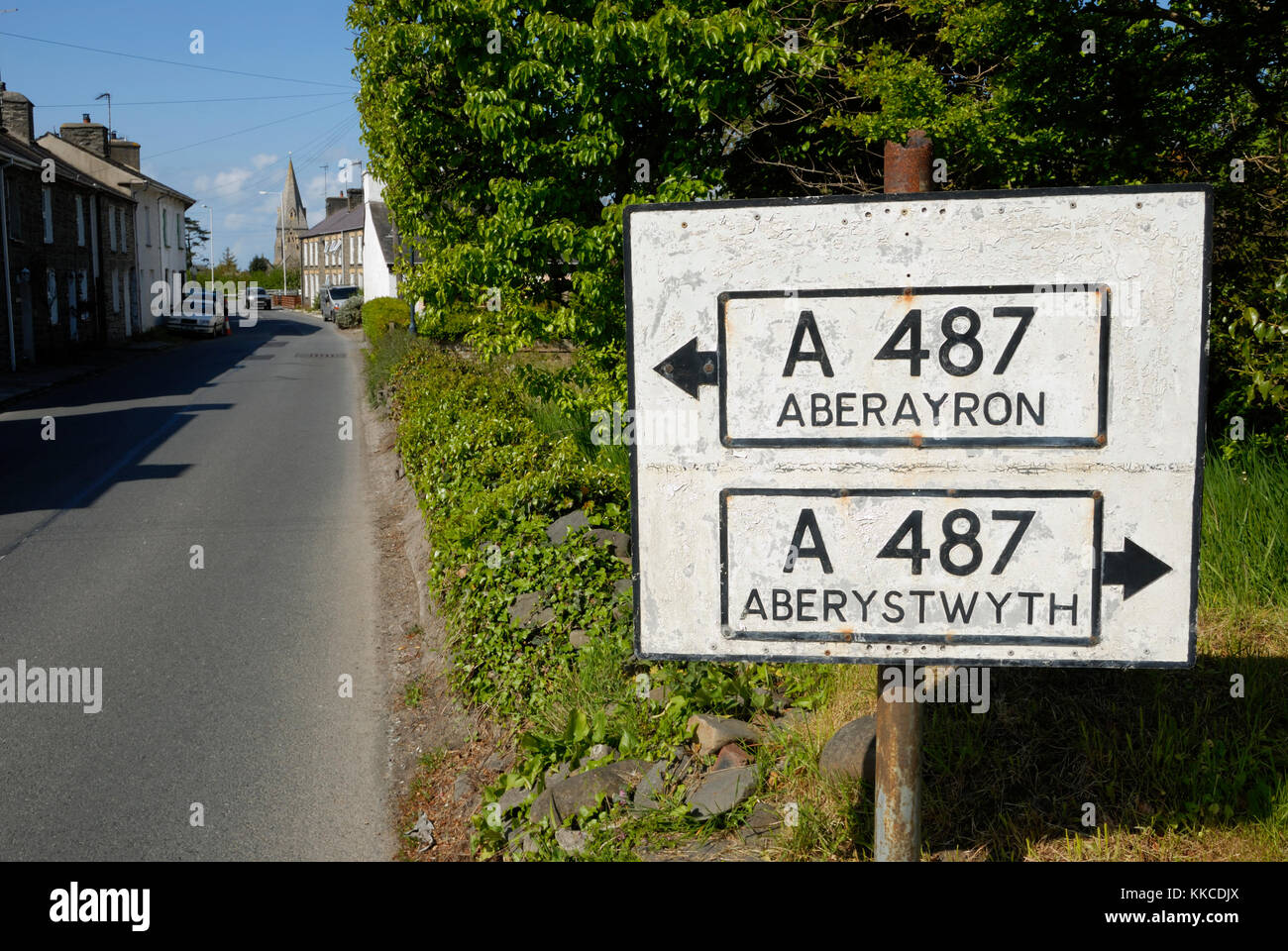 Signpost in Llanrhystud village using anglicised spelling of Aberaeron (Aberayron), Wales, UK. Stock Photo