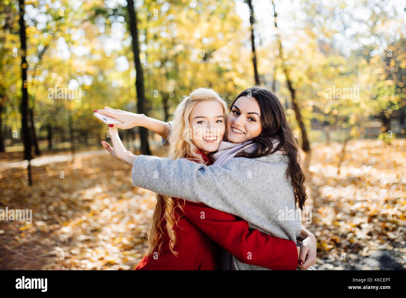 Girl hugging her best friend. In the park Stock Photo - Alamy