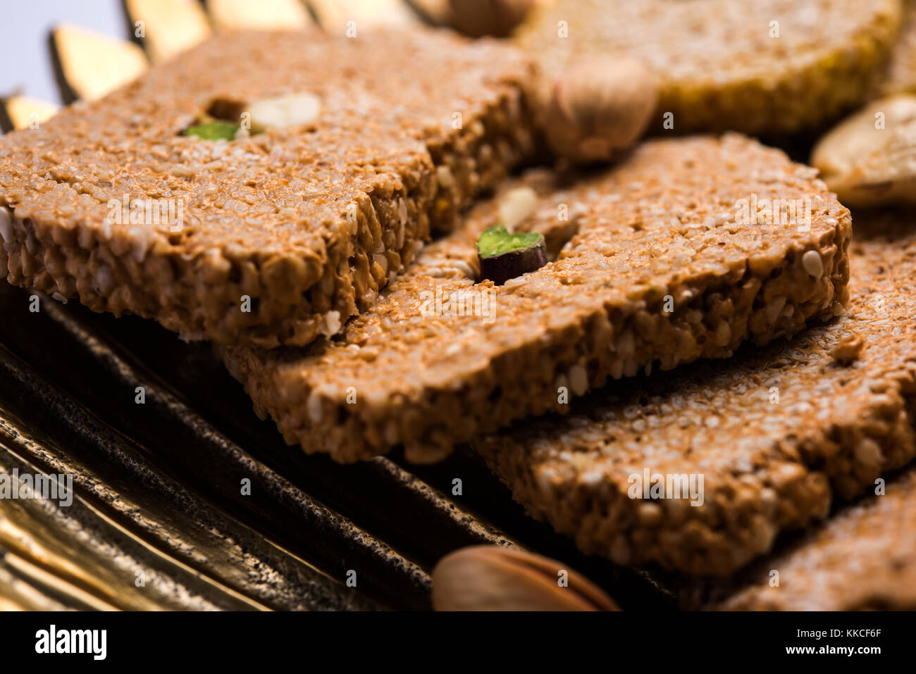 Gajak or til papdi or patti is a dry sweet cake - made of sesame seeds, ground nuts and jaggery, consumed in indian winter especially during Makar San Stock Photo
