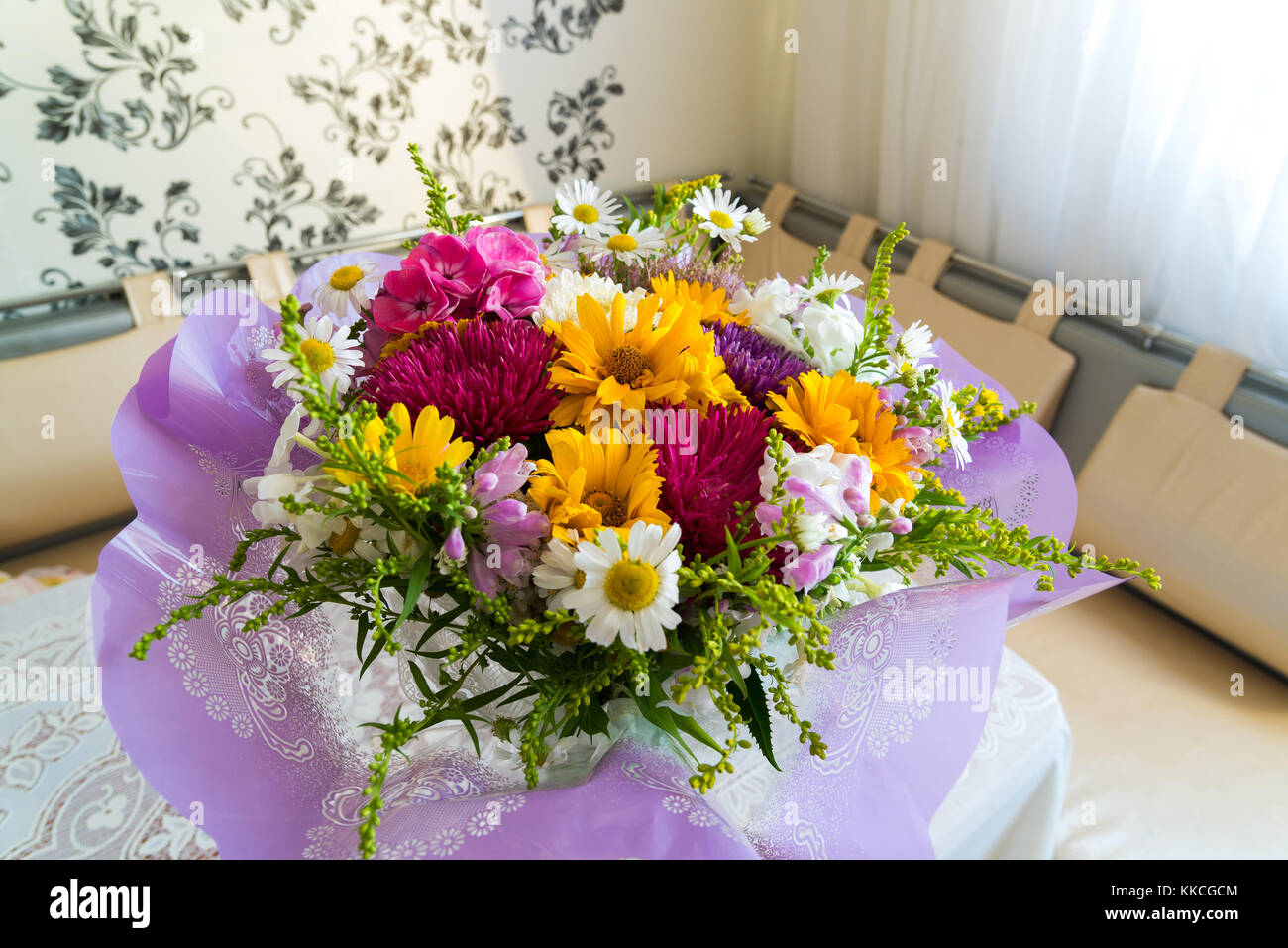 Bouquet of flowers on table in the room Stock Photo Alamy