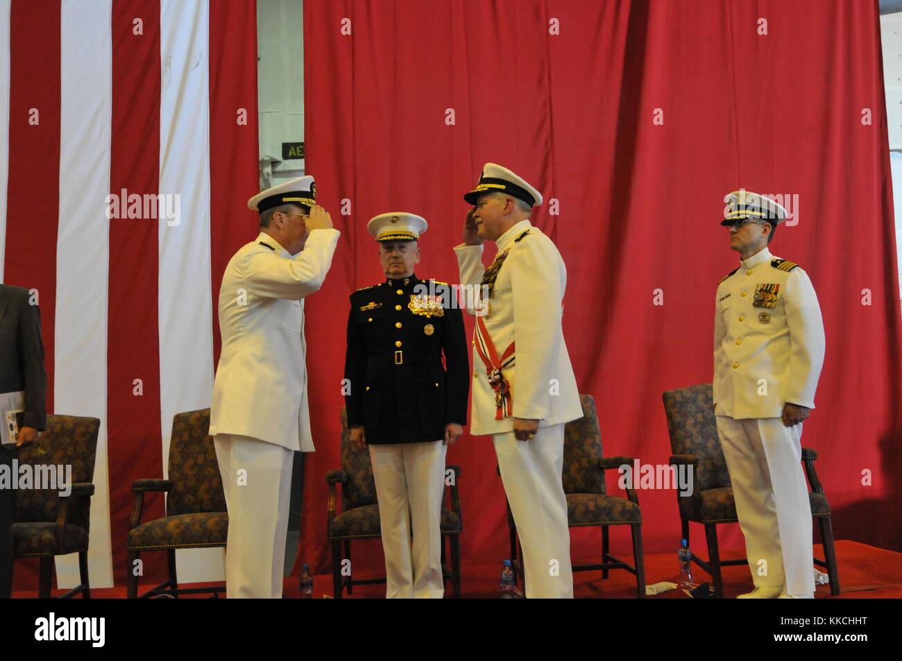 Vice Admiral John Miller, left, relieves Vice Admiral Mark Fox as commander of US, Khalifa Bin