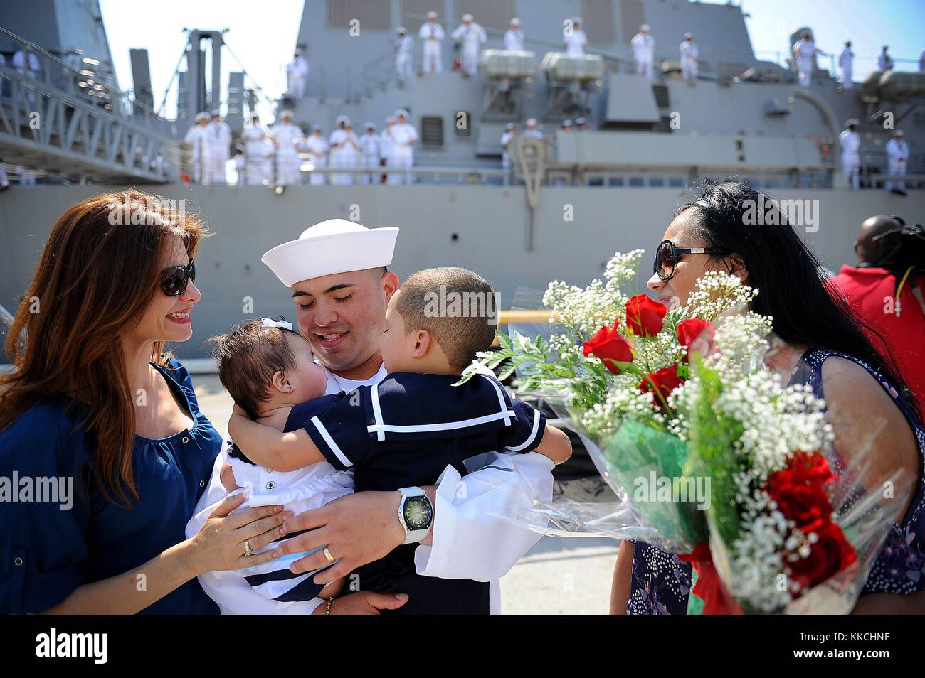 Ship's Serviceman 3rd Class Robert Gomez, assigned to the Arleigh Burke-class guided-missile destroyer USS The Sullivans DDG 68, sees his newborn daughter for the first time during a homecoming celebration at Naval Station Mayport, Mayport, Florida. Image courtesy Mass Communication Specialist Seaman Apprentice Damian Berg/US Navy. 2012. Stock Photo